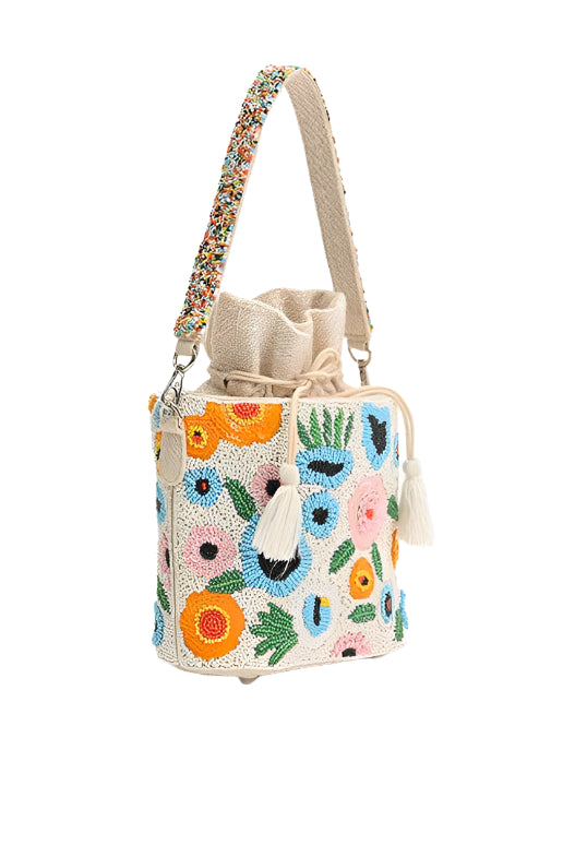Handbag with floral embroidery and colorful beads on a white background